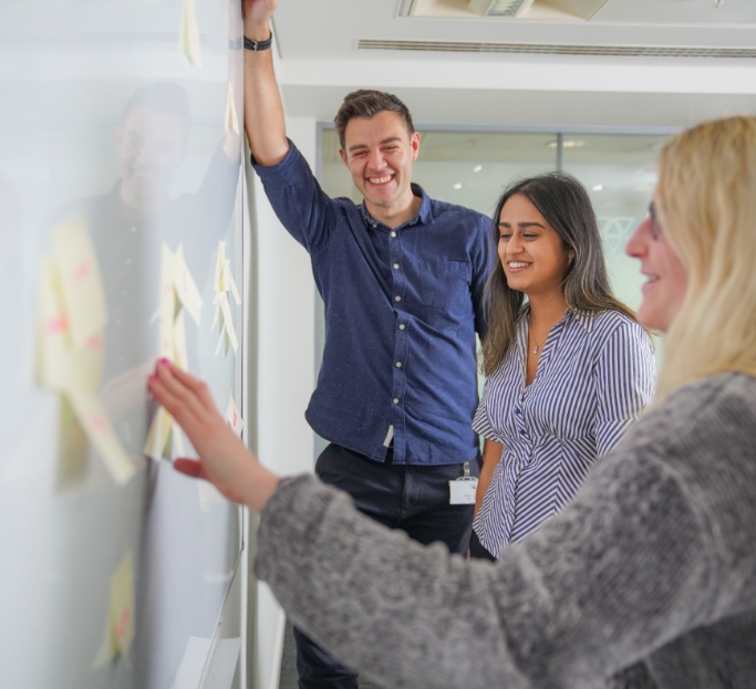 Corporates employees discussing over whiteboard 